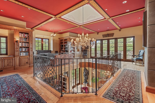 13320 Signal Tree, Potomac, MD 20854 - hallway with a chandelier, coffered ceiling, an upstairs landing, beam ceiling, and wood finished floors