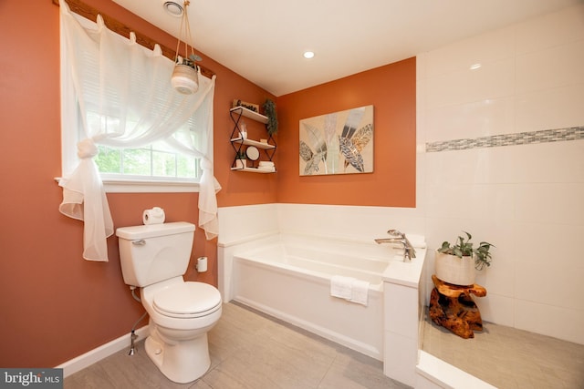 bathroom with toilet, a garden tub, baseboards, and recessed lighting