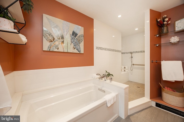 full bathroom with a garden tub, recessed lighting, and walk in shower
