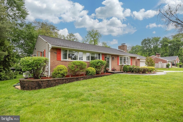 single story home with a chimney, a front yard, brick siding, and driveway