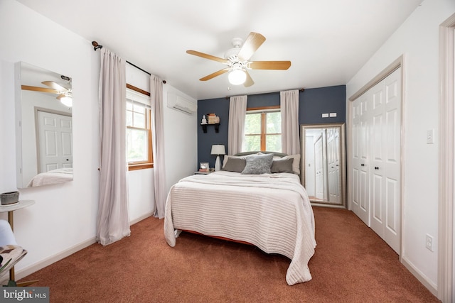 carpeted bedroom featuring a wall unit AC, a ceiling fan, and baseboards
