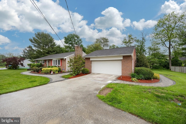 ranch-style house featuring brick siding, driveway, a front yard, a garage, and a chimney