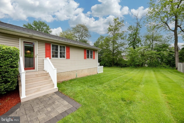 view of grassy yard with entry steps