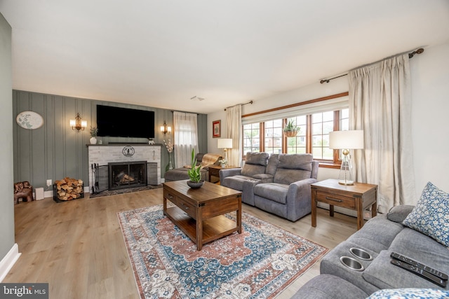 living area featuring a fireplace and light wood-type flooring