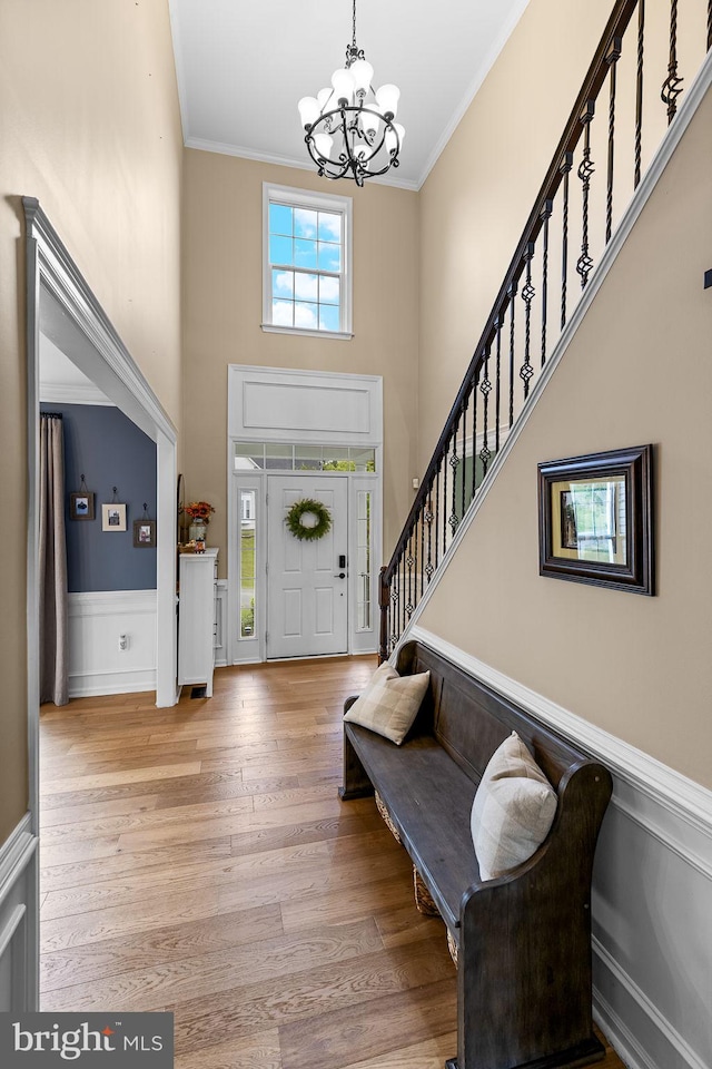 4 Saint Vincent Ct, Stafford, VA 22556 - entrance foyer featuring a chandelier, a high ceiling, stairs, ornamental molding, and wood finished floors