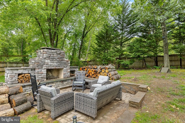 4 Saint Vincent Ct, Stafford, VA 22556 - fenced backyard featuring an outdoor stone fireplace, a patio, and view of scattered trees