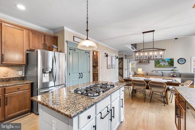 4 Saint Vincent Ct, Stafford, VA 22556 - kitchen with appliances with stainless steel finishes, light wood finished floors, brown cabinets, open floor plan, and crown molding