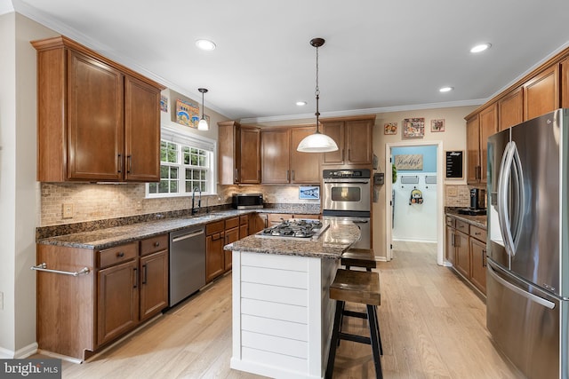 4 Saint Vincent Ct, Stafford, VA 22556 - kitchen featuring stainless steel appliances, crown molding, decorative backsplash, a kitchen breakfast bar, and light wood-type flooring