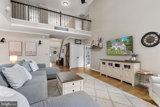 4 Saint Vincent Ct, Stafford, VA 22556 - living area featuring a high ceiling, wood finished floors, ornamental molding, and baseboards