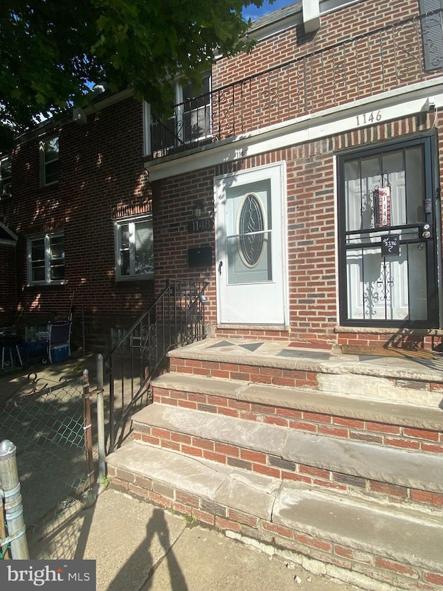 1148 Slocum St, Philadelphia, PA 19150 - entrance to property with brick siding, a balcony, and a gate