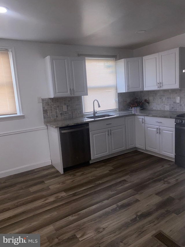 1148 Slocum St, Philadelphia, PA 19150 - kitchen with dishwasher, a sink, white cabinets, tasteful backsplash, and stove