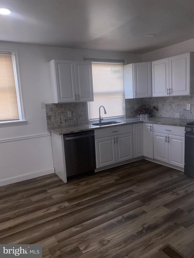 1148 Slocum St, Philadelphia, PA 19150 - kitchen with stainless steel dishwasher, a sink, backsplash, and white cabinets