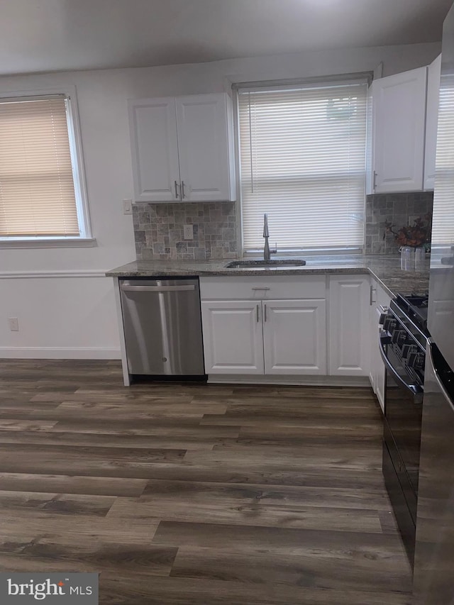 1148 Slocum St, Philadelphia, PA 19150 - kitchen with dishwasher, a sink, gas stove, and white cabinetry