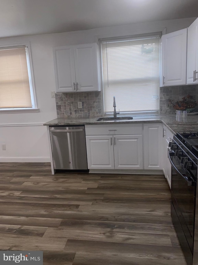 1148 Slocum St, Philadelphia, PA 19150 - kitchen with stainless steel dishwasher, a sink, black gas stove, and white cabinetry
