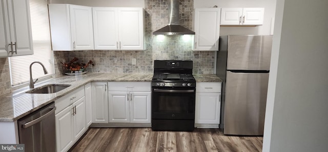 1148 Slocum St, Philadelphia, PA 19150 - kitchen featuring stainless steel appliances, wall chimney range hood, a sink, and decorative backsplash