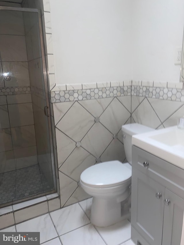1148 Slocum St, Philadelphia, PA 19150 - bathroom with tile walls, vanity, a shower stall, toilet, and wainscoting