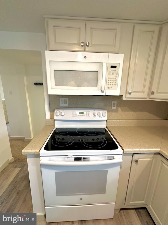 118 Hopewell St, Birdsboro, PA 19508 - kitchen with white appliances, light wood finished floors, light countertops, and white cabinets