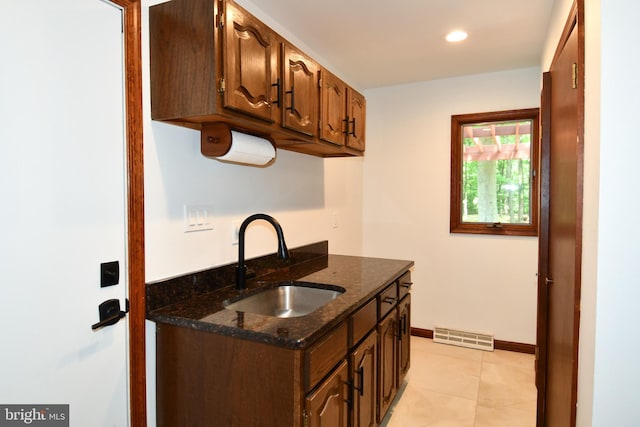 2410 Mill Branch Rd, Bowie, MD 20716 - kitchen featuring dark stone counters, light tile patterned floors, and recessed lighting