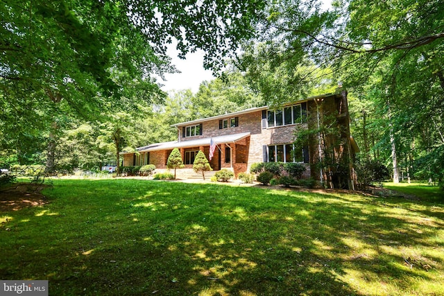 2410 Mill Branch Rd, Bowie, MD 20716 - view of front of house featuring a front lawn, covered porch, and brick siding