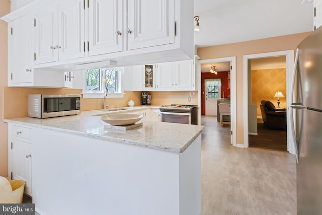 575 Millcross Rd, Lancaster, PA 17601 - kitchen featuring appliances with stainless steel finishes, a sink, white cabinetry, a peninsula, and light stone countertops