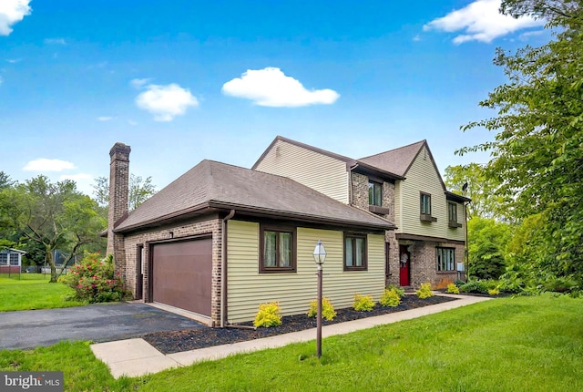 575 Millcross Rd, Lancaster, PA 17601 - view of front of house featuring brick siding, a chimney, driveway, a front yard, and a garage