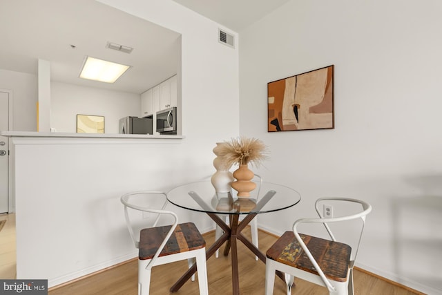 2001 12th St NW Unit 410, Washington, DC 20009 - dining area featuring light wood-style flooring and baseboards