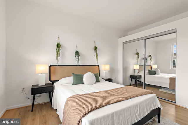 2001 12th St NW Unit 410, Washington, DC 20009 - bedroom with light wood-style floors, baseboards, and a closet