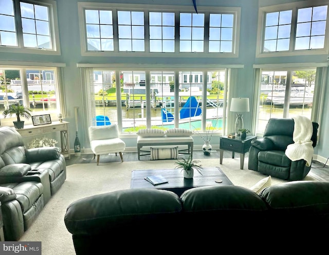 8 Leslie Mews, Berlin, MD 21811 - carpeted living area featuring a towering ceiling, a water view, and baseboards