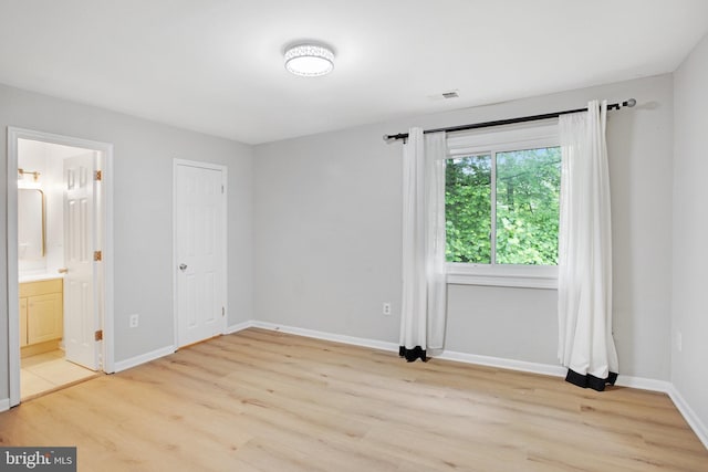 54 Austin Run Blvd, Stafford, VA 22554 - unfurnished bedroom with light wood finished floors, baseboards, and ensuite bath