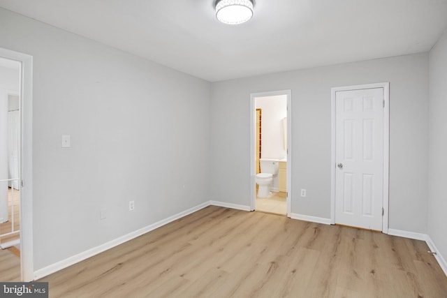 54 Austin Run Blvd, Stafford, VA 22554 - unfurnished bedroom with wood finished floors, baseboards, and connected bathroom