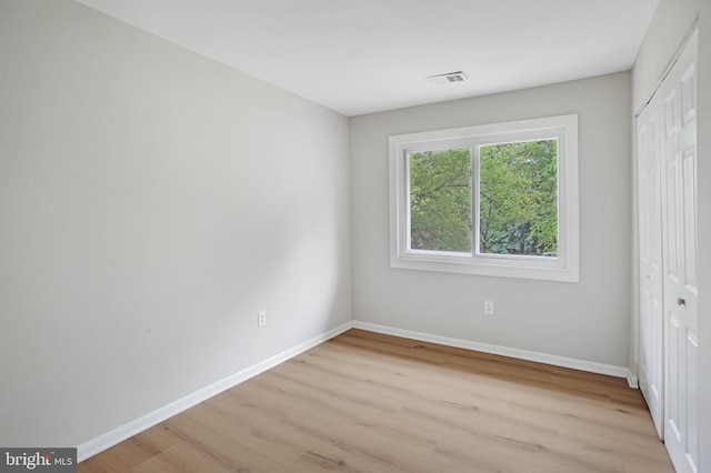 54 Austin Run Blvd, Stafford, VA 22554 - unfurnished bedroom with light wood finished floors, a closet, and baseboards