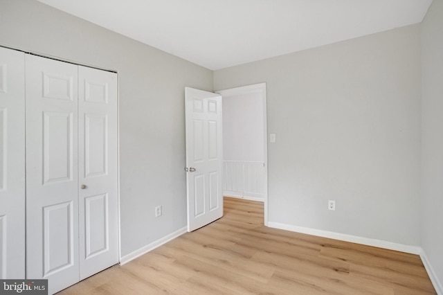 54 Austin Run Blvd, Stafford, VA 22554 - unfurnished bedroom with light wood-style flooring, baseboards, and a closet