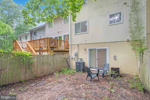 54 Austin Run Blvd, Stafford, VA 22554 - rear view of property featuring central AC, a fenced backyard, a deck, and stucco siding