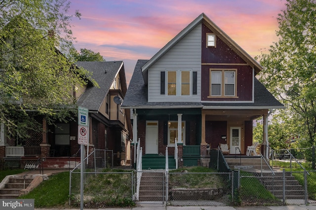 2405 N 5th St, Harrisburg, PA 17110 - view of front of home with covered porch, a gate, a fenced front yard, brick siding, and a shingled roof