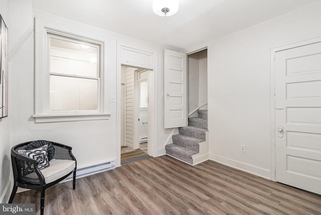 2405 N 5th St, Harrisburg, PA 17110 - unfurnished room featuring wood finished floors, baseboards, stairs, and baseboard heating
