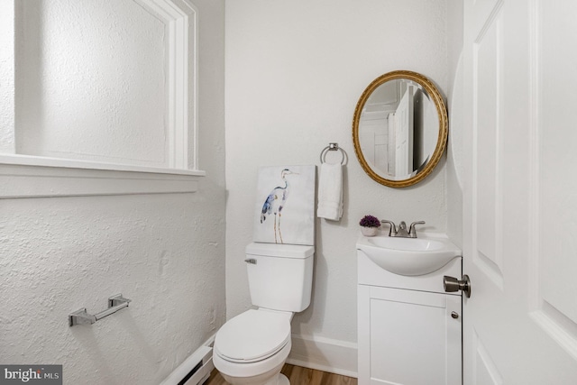 2405 N 5th St, Harrisburg, PA 17110 - bathroom with toilet, vanity, baseboards, and wood finished floors