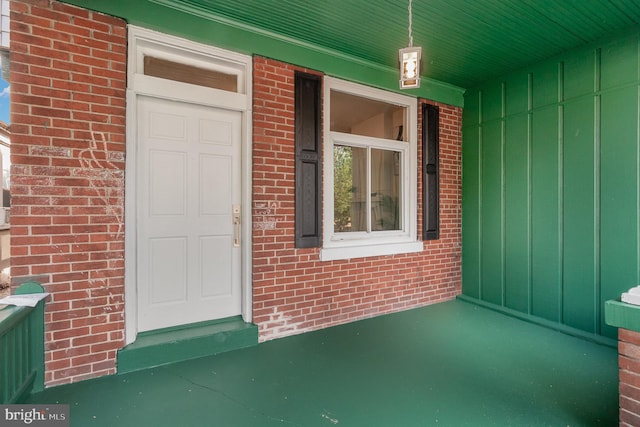2405 N 5th St, Harrisburg, PA 17110 - view of exterior entry featuring brick siding, a porch, and board and batten siding