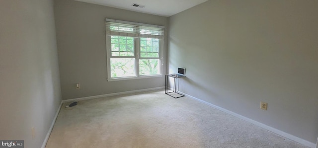 spare room with baseboards and carpet flooring
