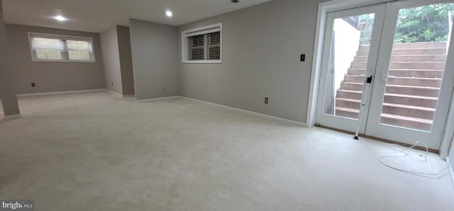 unfurnished room featuring light colored carpet, baseboards, stairs, and recessed lighting