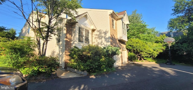 view of property exterior with brick siding