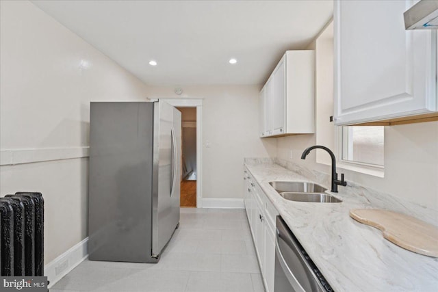 728 13th St SE, Washington, DC 20003 - kitchen featuring stainless steel appliances, radiator, light stone countertops, white cabinetry, and recessed lighting