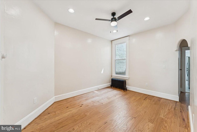 728 13th St SE, Washington, DC 20003 - spare room featuring radiator heating unit, ceiling fan, arched walkways, wood finished floors, and recessed lighting