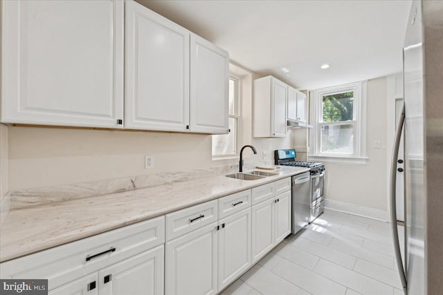 728 13th St SE, Washington, DC 20003 - kitchen featuring stainless steel appliances, white cabinets, light tile patterned floors, light stone countertops, and under cabinet range hood