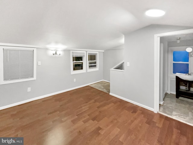 10811 Pearson St, Kensington, MD 20895 - unfurnished living room featuring wood finished floors, vaulted ceiling, and baseboards