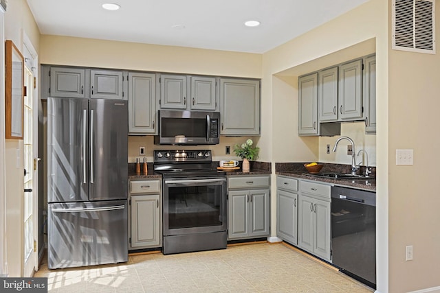 1205 Bond St, Herndon, VA 20170 - kitchen featuring stainless steel appliances, gray cabinetry, recessed lighting, and dark stone countertops
