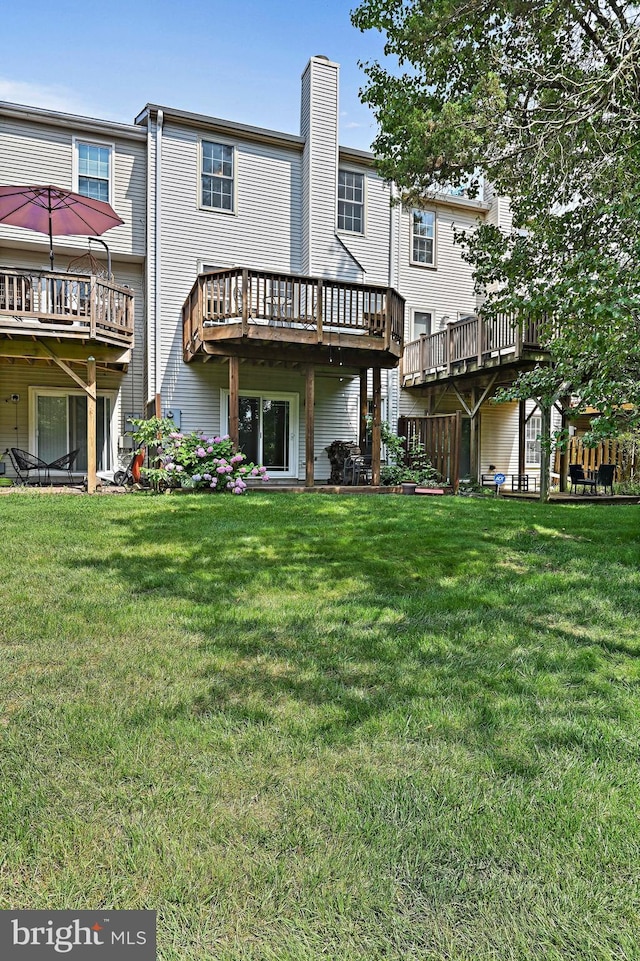 1205 Bond St, Herndon, VA 20170 - back of house featuring a lawn, a chimney, and a deck