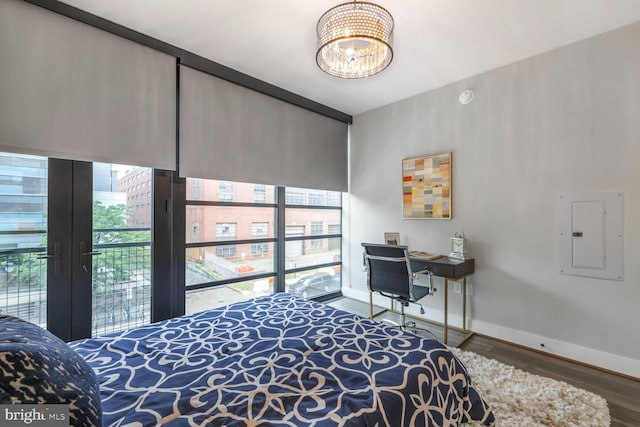 1300 4th St SE Unit 214, Washington, DC 20003 - bedroom with electric panel, baseboards, wood finished floors, a chandelier, and floor to ceiling windows