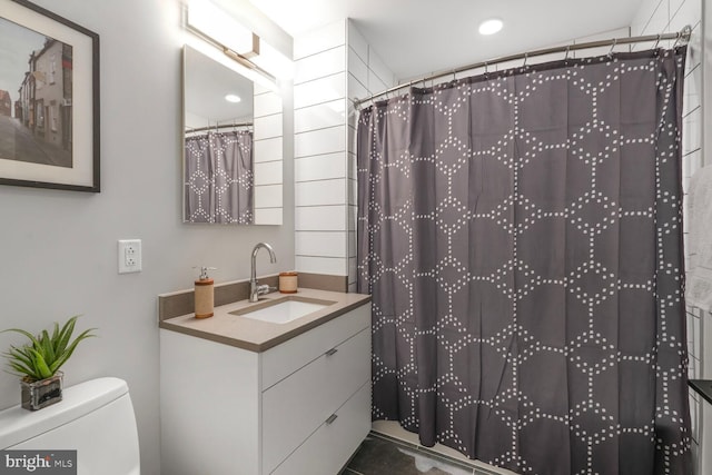 1300 4th St SE Unit 214, Washington, DC 20003 - bathroom with vanity, toilet, a shower with shower curtain, and recessed lighting