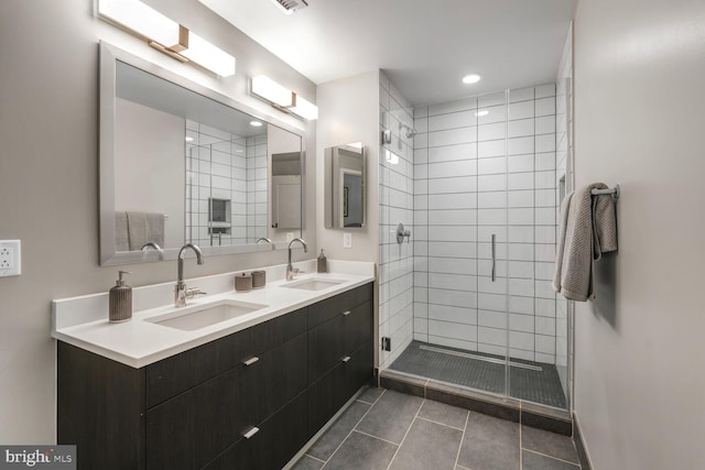 1300 4th St SE Unit 214, Washington, DC 20003 - bathroom featuring double vanity, tile patterned flooring, a stall shower, and recessed lighting