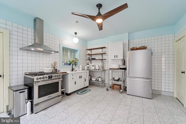 5811 Mcmahon St, Philadelphia, PA 19144 - kitchen with appliances with stainless steel finishes, exhaust hood, tile walls, a sink, and dark speckled floor